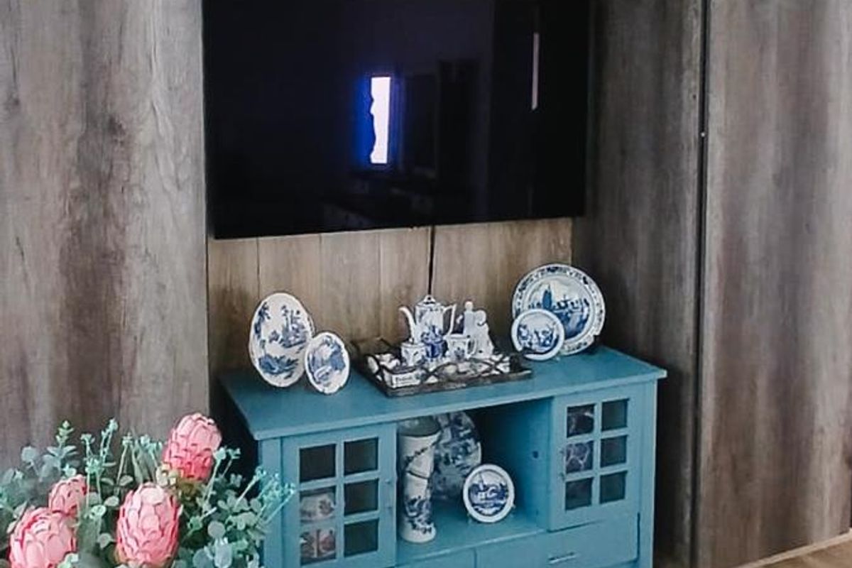 A living room featuring a built-in wood-look cabinetry unit with integrated storage and shelving.