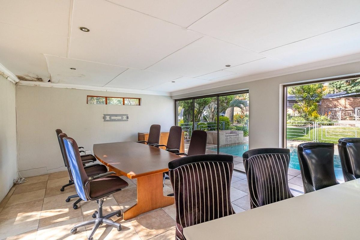 Spacious room featuring large sliding glass doors with direct access to the pool area, tiled flooring, and recessed ceiling lighting.