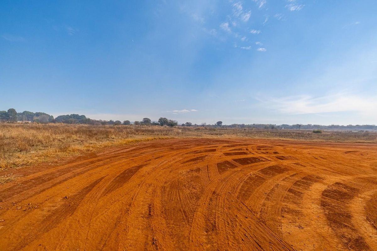 Expansive undeveloped commercial land featuring natural terrain and open space, suitable for future development or industrial use.