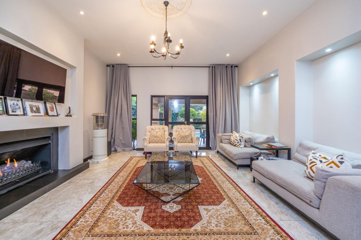 Spacious living room featuring a built-in fireplace, tiled flooring, recessed lighting, and direct access to the outdoor patio area.