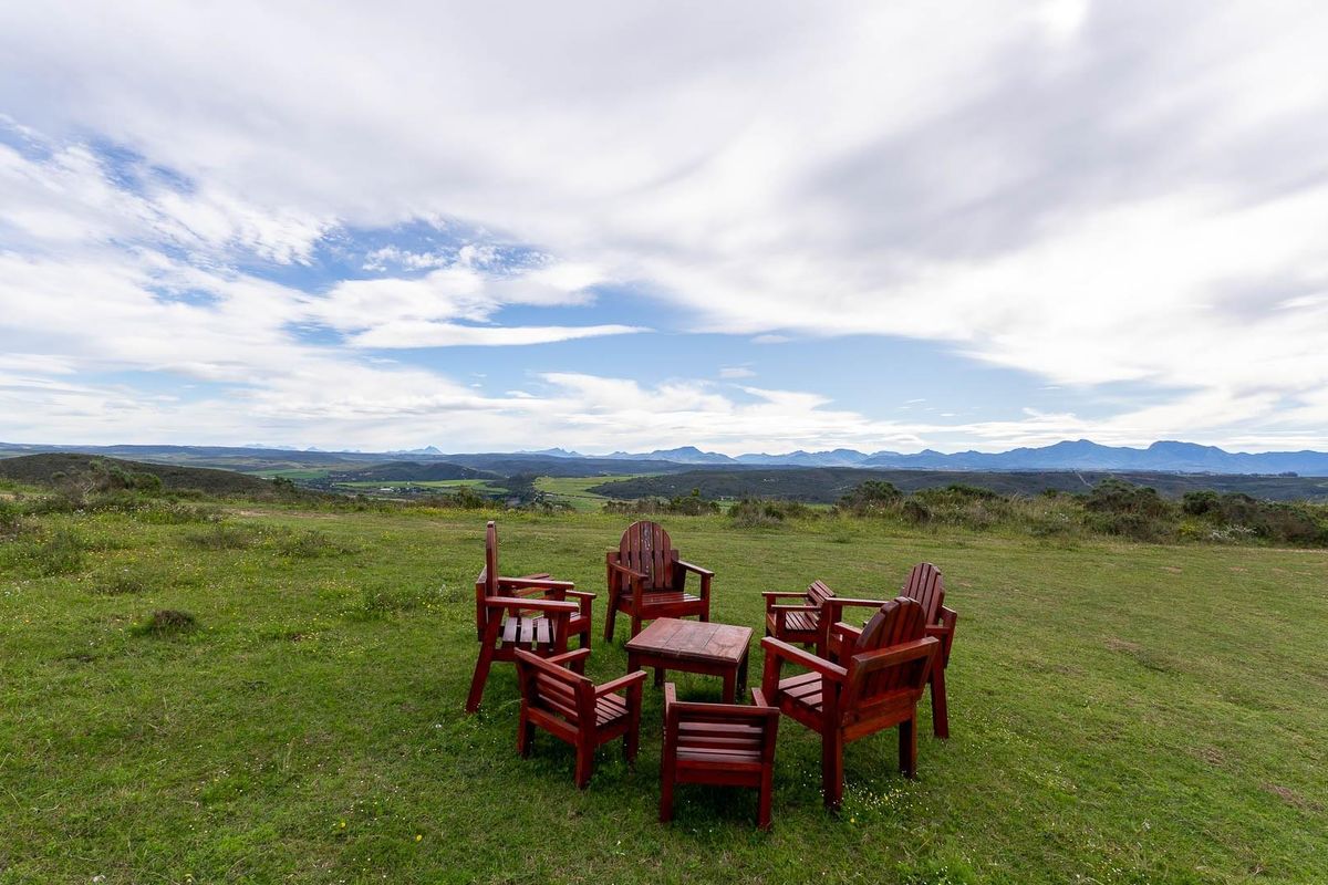 Expansive panoramic view of the surrounding landscape and distant mountain ranges from the vacant residential land.