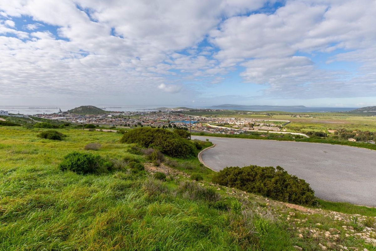 Elevated view overlooking the surrounding residential landscape and distant coastline from the vacant land plot.