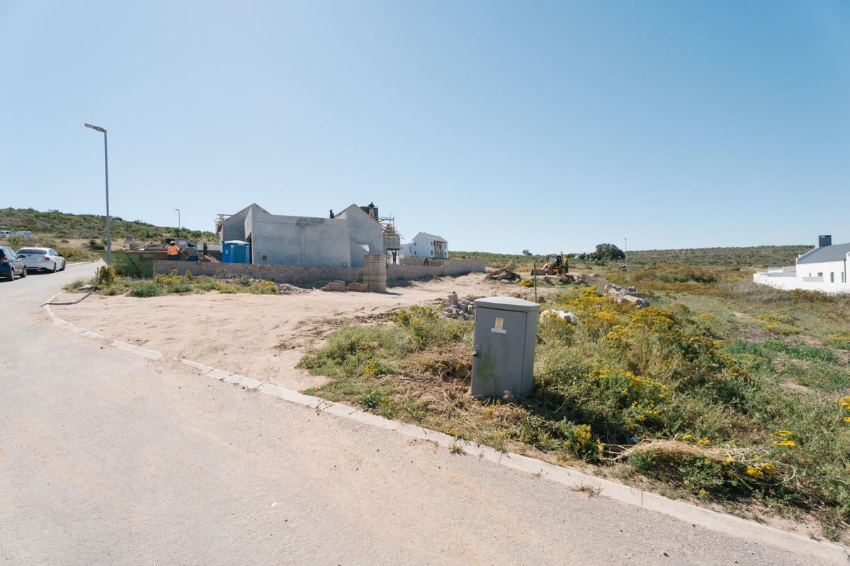 A view of a residential vacant land plot currently under construction with visible building shell and site infrastructure.