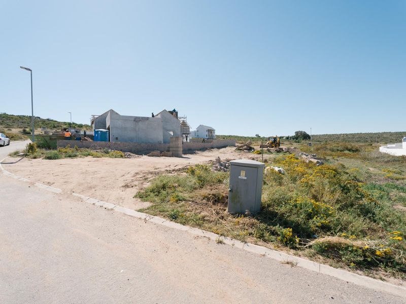 A view of a residential vacant land plot currently under construction with visible building shell and site infrastructure.