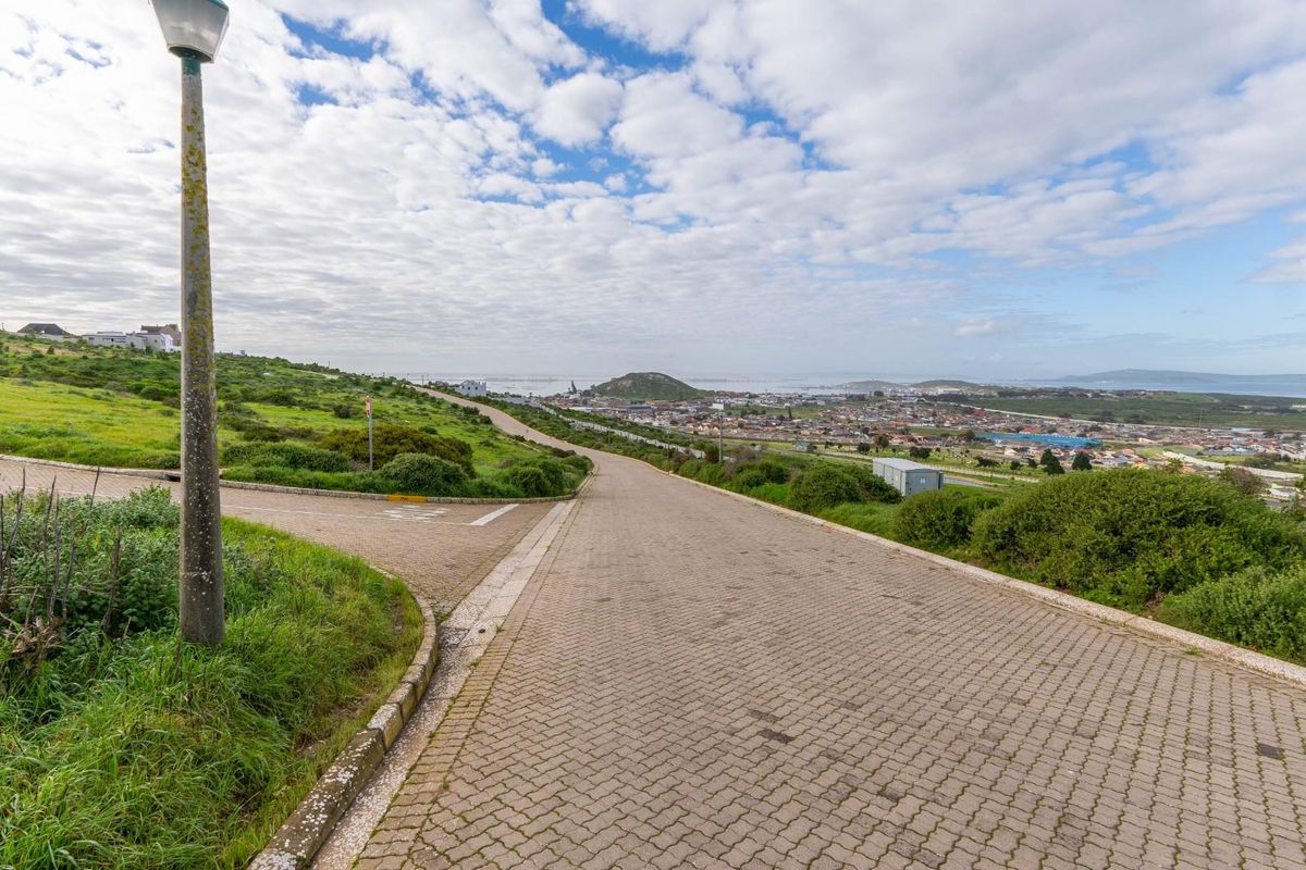 A view of the paved street infrastructure and surrounding landscape within the residential estate.
