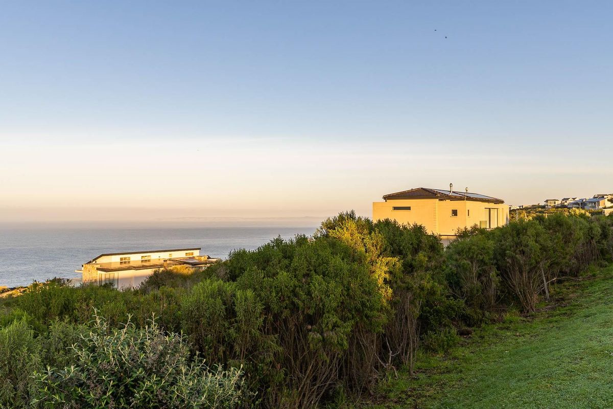 A scenic coastal view overlooking the ocean and surrounding residential landscape, highlighting the property's elevated position and natural surroundings.