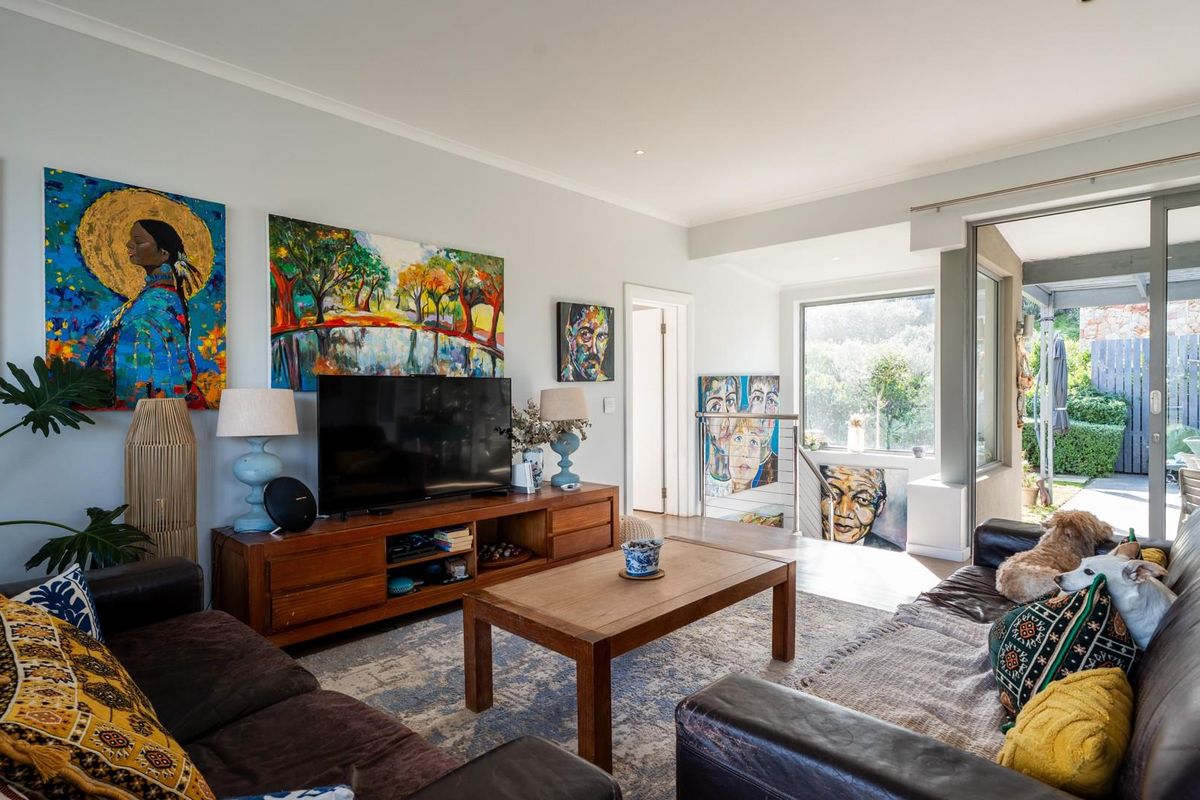 A bright living room featuring large sliding glass doors that provide natural light and access to an outdoor patio area.