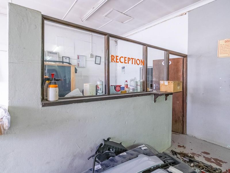 A functional utility or reception area featuring a glass partition screen, suitable for office or commercial use.