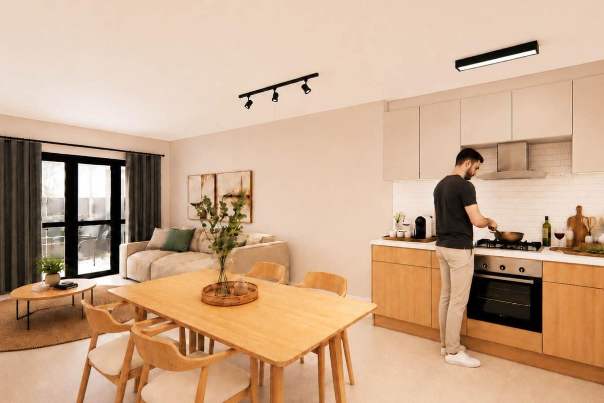 Modern open-plan living area featuring a contemporary kitchen with built-in appliances, subway tile backsplash, and seamless flow to the outdoor patio area.