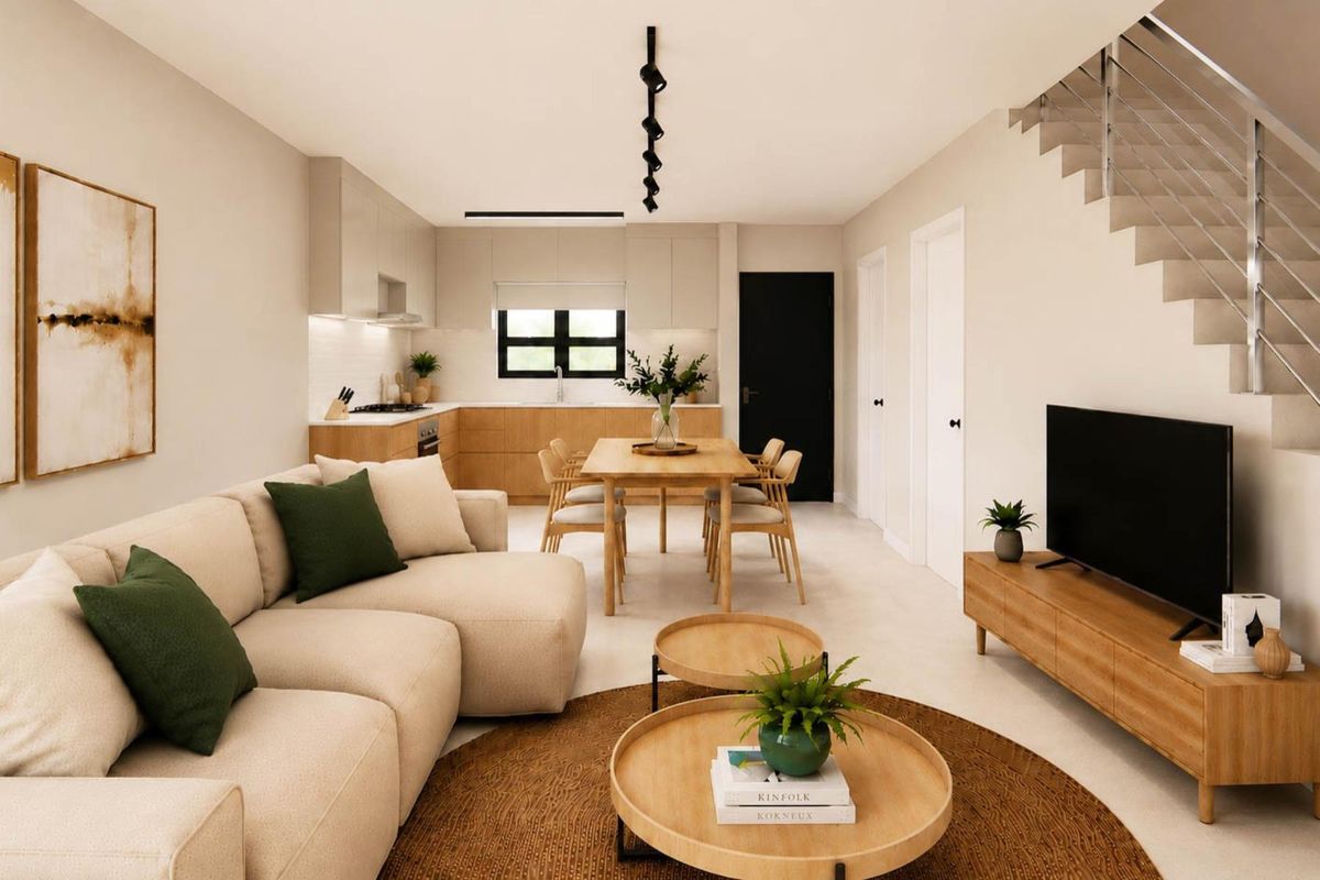 Modern open-plan living and dining area featuring a sleek kitchen with built-in cabinetry, integrated appliances, and a contemporary staircase with metal railing.