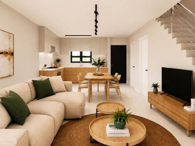 Modern open-plan living and dining area featuring a sleek kitchen with built-in cabinetry, integrated appliances, and a contemporary staircase with metal railing.