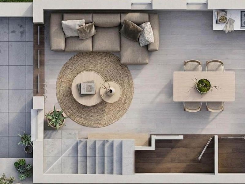 A top-down architectural floor plan rendering showing the layout of an open-plan living, dining, and kitchen area with an adjacent staircase.