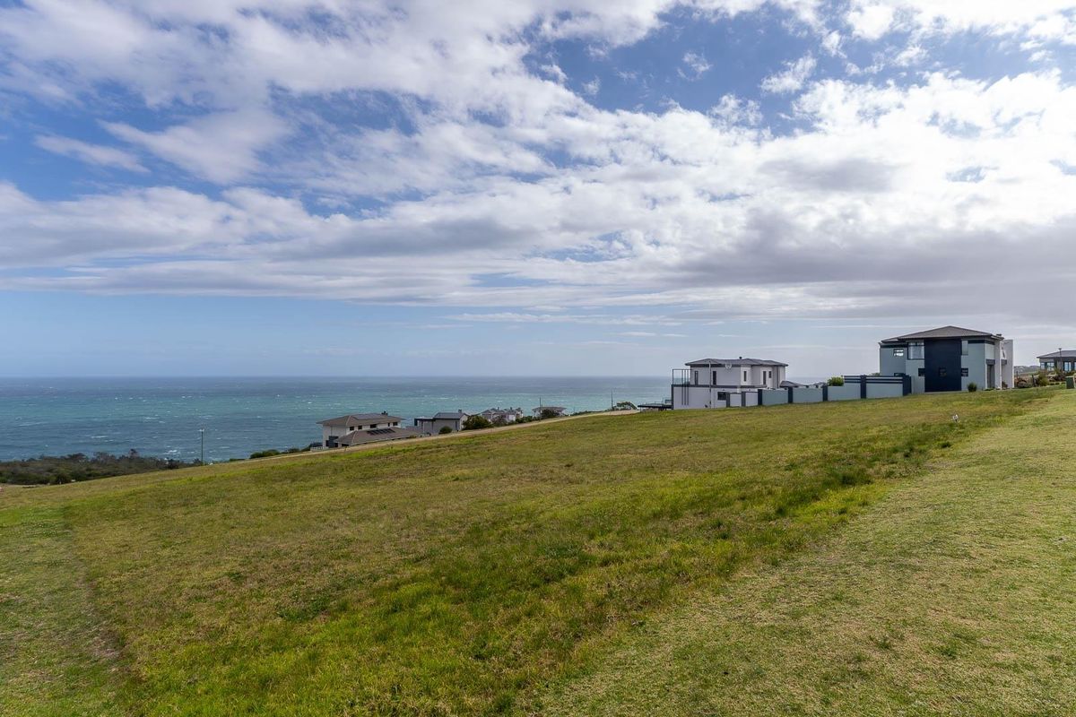 A scenic view of the coastal landscape and surrounding residential properties from the vacant land plot.