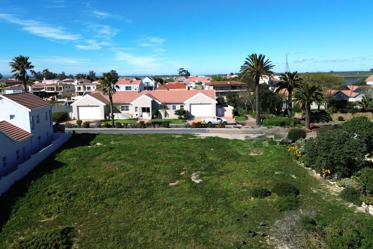 An aerial view of a vacant residential plot situated in a developed neighborhood, offering potential for new construction.