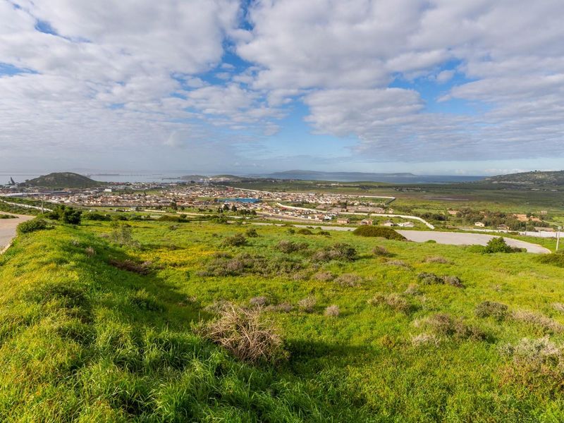 Expansive elevated view overlooking the surrounding residential landscape and distant coastal horizon from the vacant land plot.