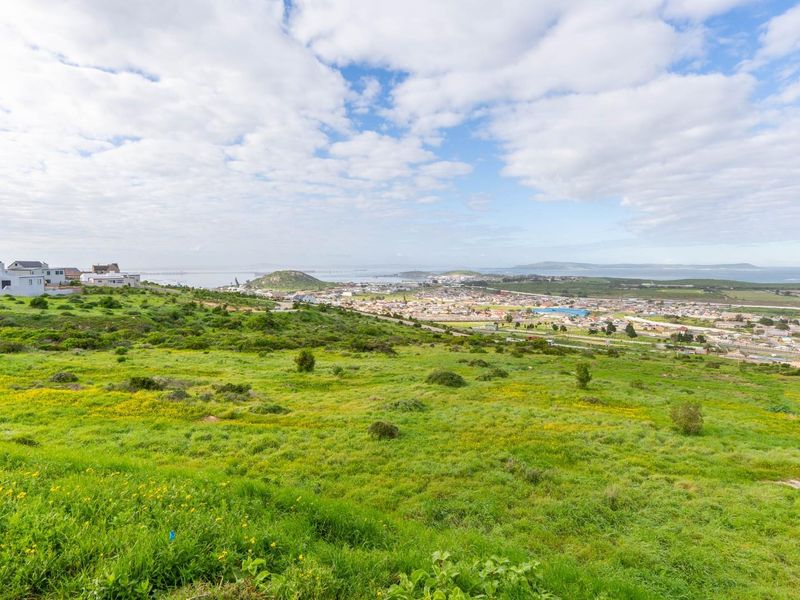 A wide-angle view of the vacant residential land overlooking the surrounding coastal town and landscape.