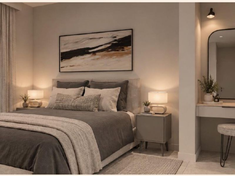 A modern, well-appointed bedroom featuring a built-in vanity area with integrated lighting and a sleek, contemporary design aesthetic.
