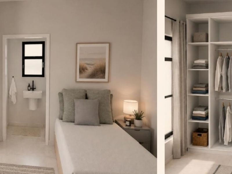 A modern bedroom featuring a built-in wardrobe and an adjoining en-suite bathroom with a wall-mounted basin.