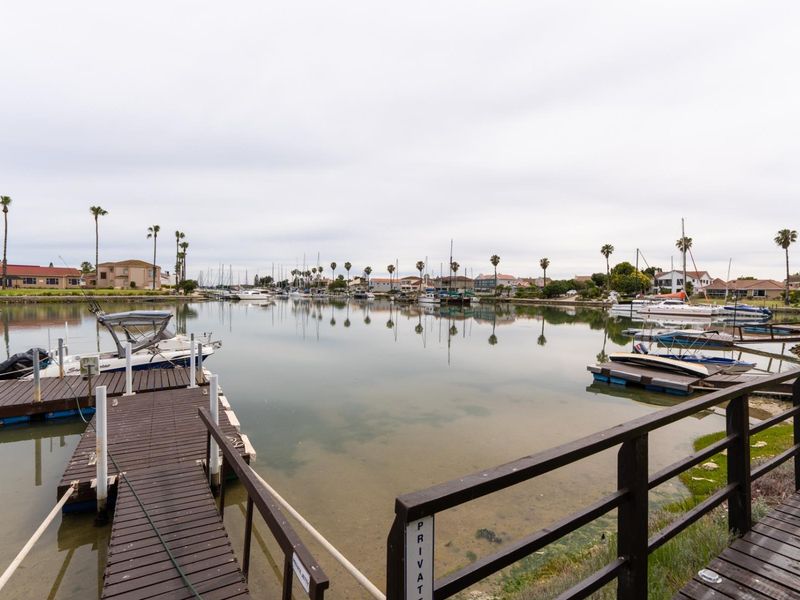 A scenic view of the estate waterway featuring private timber jetties and surrounding residential properties.