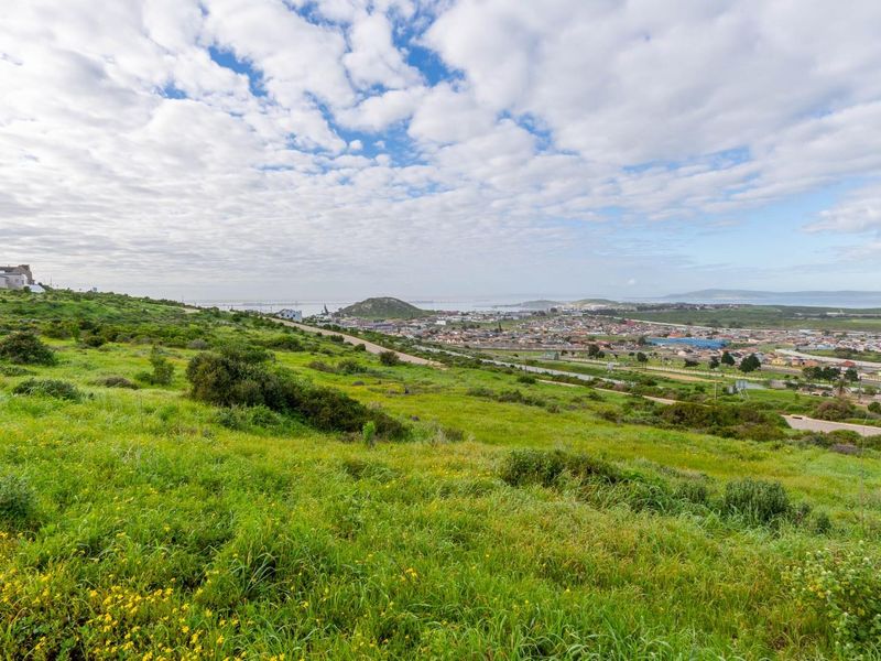 Elevated panoramic view overlooking the surrounding landscape, coastal town, and distant horizon from the vacant residential plot.