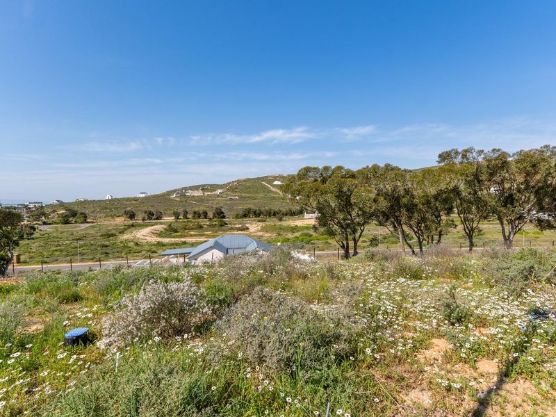 A scenic view overlooking the vacant residential land, featuring natural vegetation and surrounding landscape.