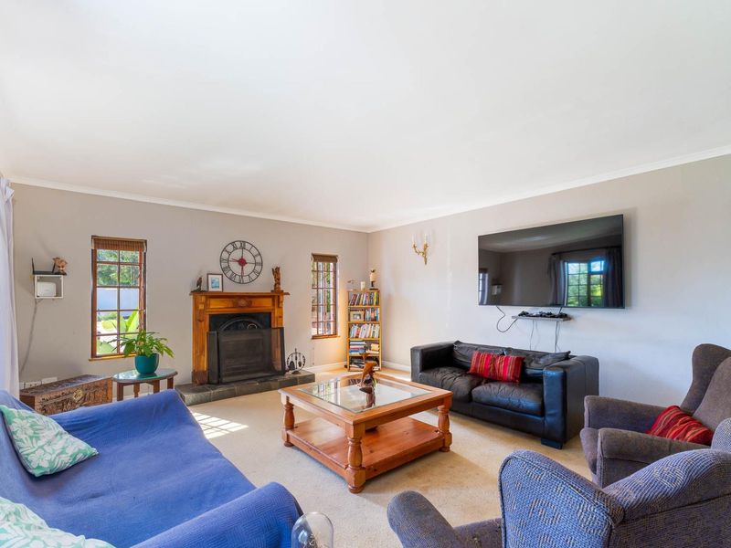 Spacious living room featuring a traditional fireplace with a timber mantelpiece and stone hearth, providing a cozy focal point for the home.