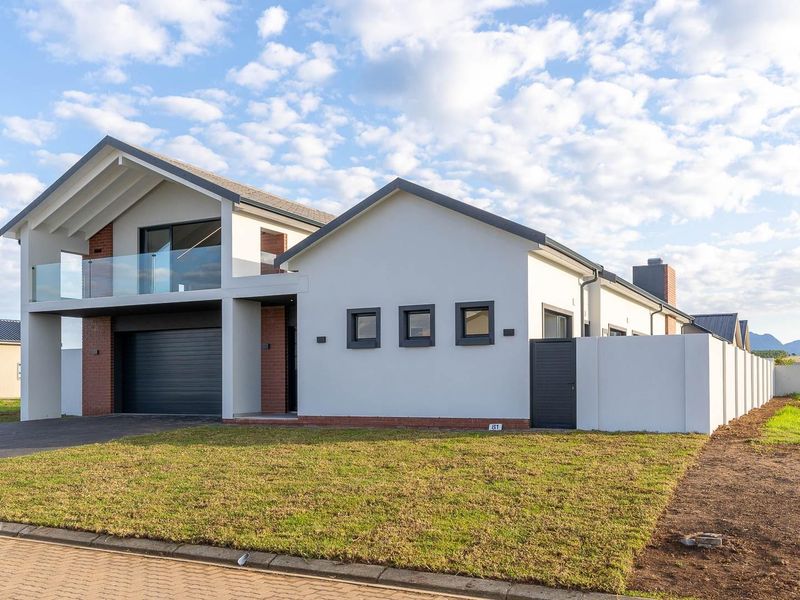 Modern double-story residential home featuring a brick and render facade, integrated double garage, and an upper-level balcony with glass balustrading.
