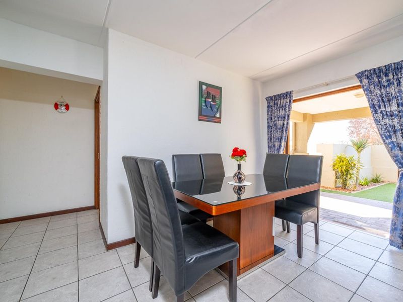Dining area featuring ceramic floor tiles and direct access to an outdoor patio through a sliding glass door.