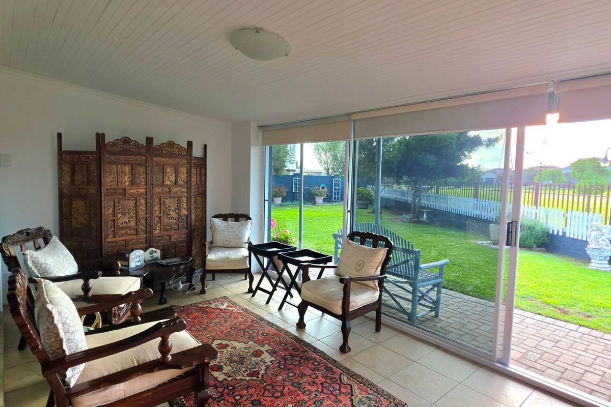 Bright living area featuring large sliding glass doors that provide seamless access to the rear garden and patio space.