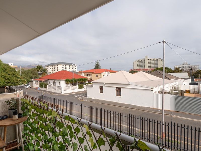 A covered balcony area offering an elevated view of the surrounding residential street and neighborhood.