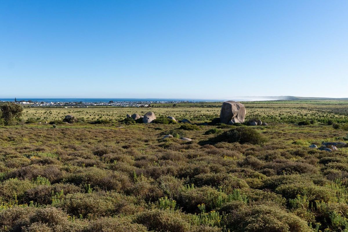 Expansive view of the natural coastal landscape and distant horizon, showcasing the open terrain of the vacant residential land.