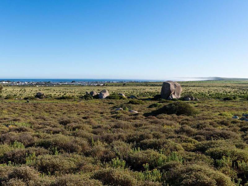 Expansive view of the natural coastal landscape and distant horizon, showcasing the open terrain of the vacant residential land.