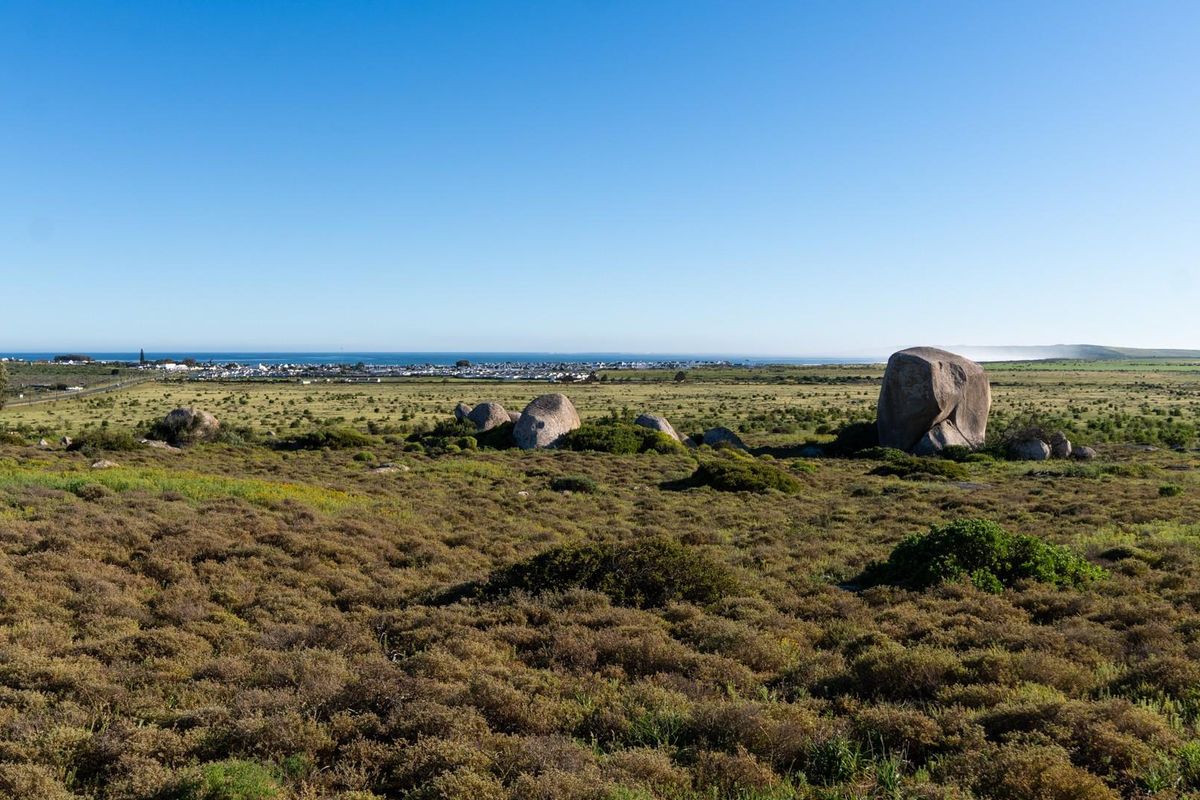 Expansive view of the coastal landscape featuring natural rock formations and distant ocean horizon.