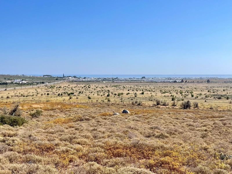 Expansive view of the surrounding landscape and distant coastline from the vacant residential plot.