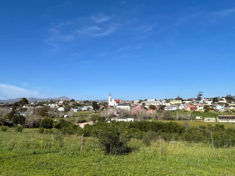 A scenic view of the surrounding residential landscape and town from the vacant land plot.