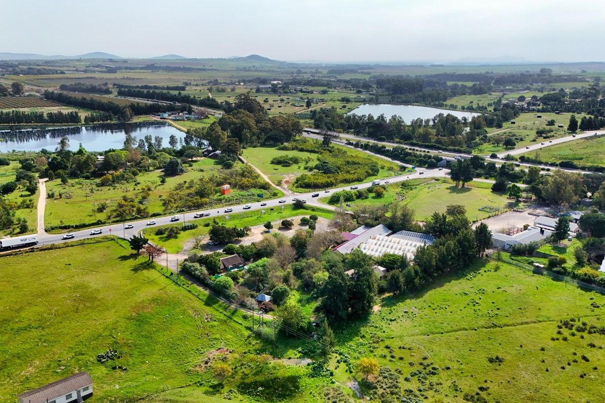 Aerial view of the commercial property showing surrounding landscape, road access, and proximity to local infrastructure and natural features.