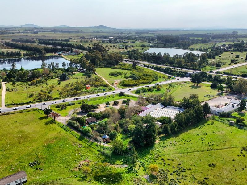 Aerial view of the commercial property showing surrounding landscape, road access, and proximity to local infrastructure and natural features.