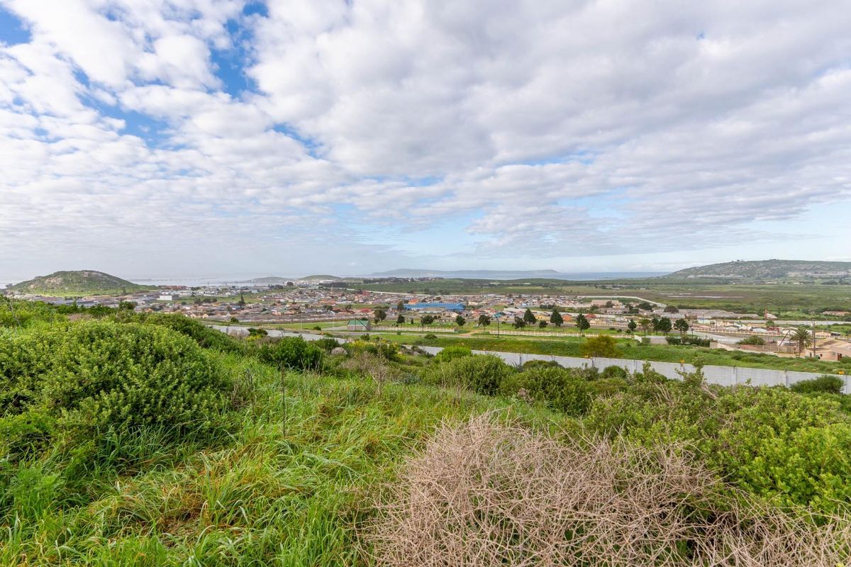 A scenic elevated view overlooking the surrounding residential area and natural landscape, showcasing the expansive outlook from the vacant land.