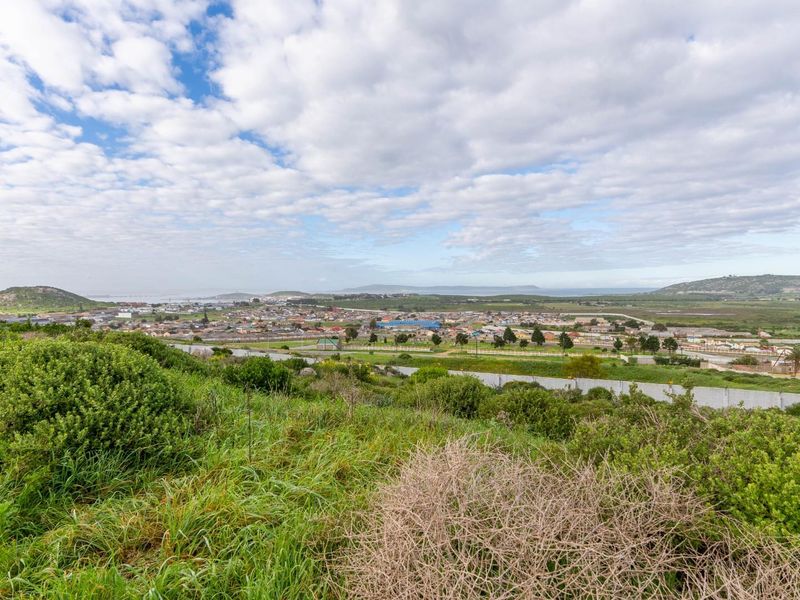 A scenic elevated view overlooking the surrounding residential area and natural landscape, showcasing the expansive outlook from the vacant land.