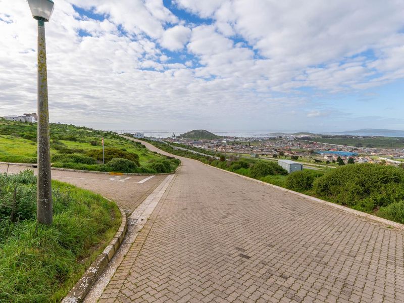 Elevated view overlooking the residential area and surrounding landscape, featuring paved access roads and established street infrastructure.