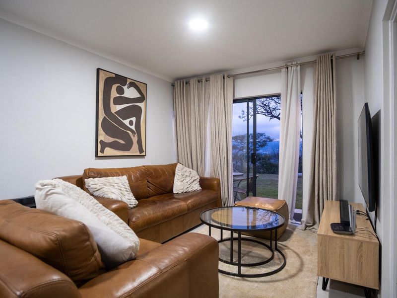 A comfortable living room featuring a sliding glass door that provides access to the outdoors and allows for natural light.