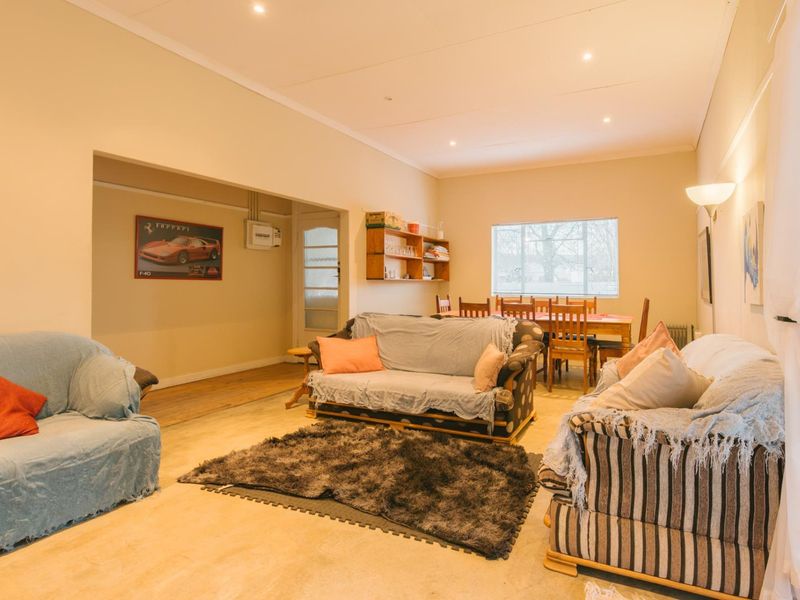 Spacious open-plan living and dining area featuring recessed lighting, coved ceilings, and built-in shelving, offering a versatile layout for family living.