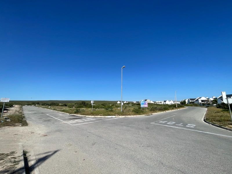 A street view showing the intersection and road infrastructure leading to the vacant residential land.