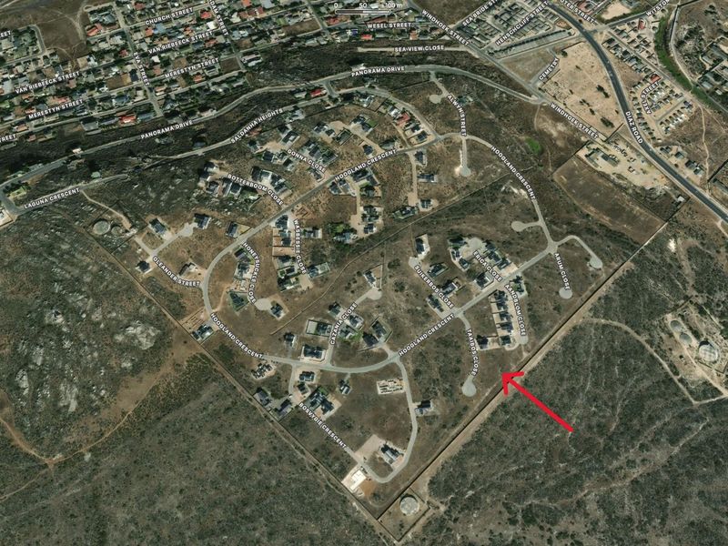 Aerial view of a residential estate development showing the layout of streets and vacant plots in a suburban setting.