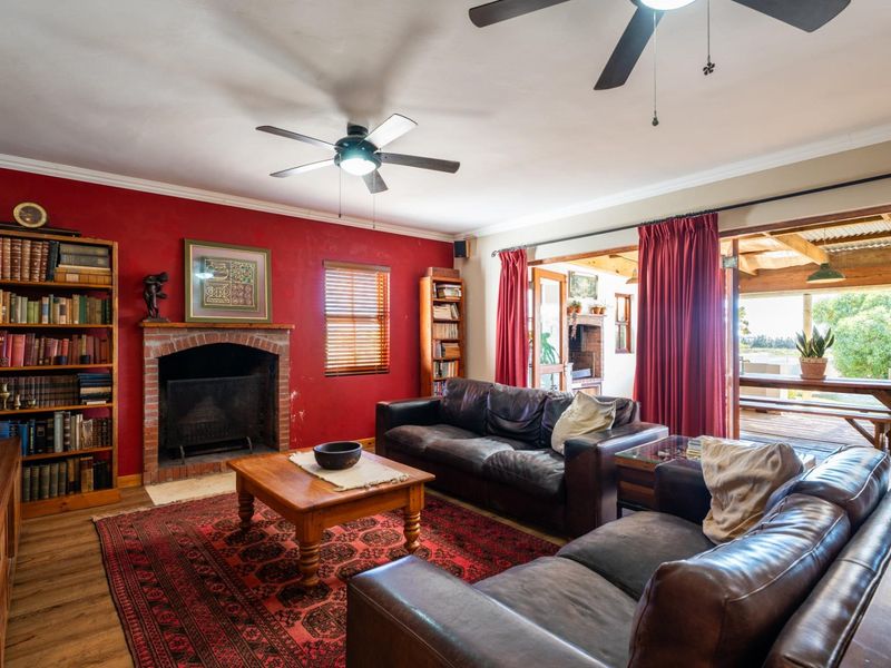 Spacious living room featuring a brick fireplace, laminate flooring, and direct access to an outdoor patio area through sliding glass doors.