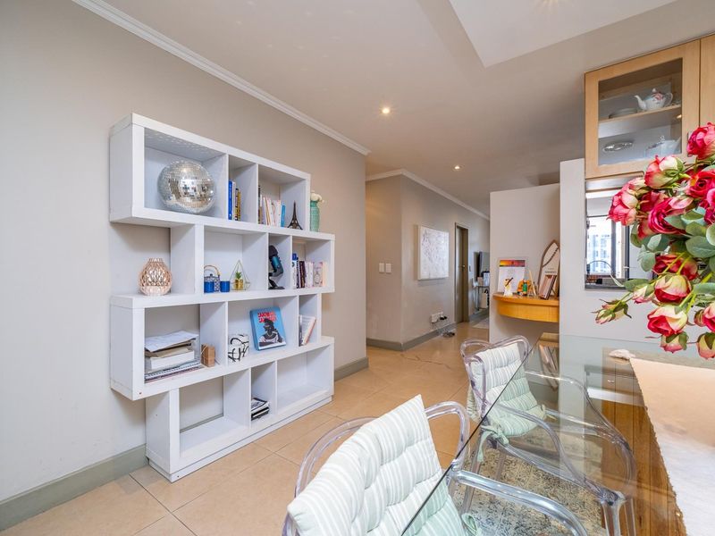 Open plan living area featuring tiled flooring, recessed downlighting, and built-in cabinetry, creating a functional and well-lit space.