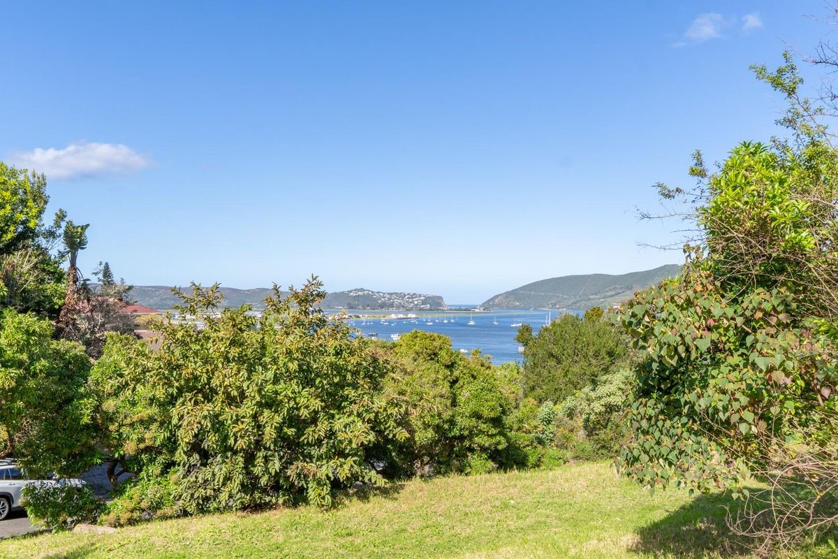 A scenic view overlooking the lagoon and surrounding hills, showcasing the natural landscape and elevated position of the vacant residential land.
