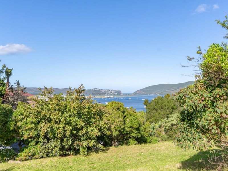 A scenic view overlooking the lagoon and surrounding hills, showcasing the natural landscape and elevated position of the vacant residential land.