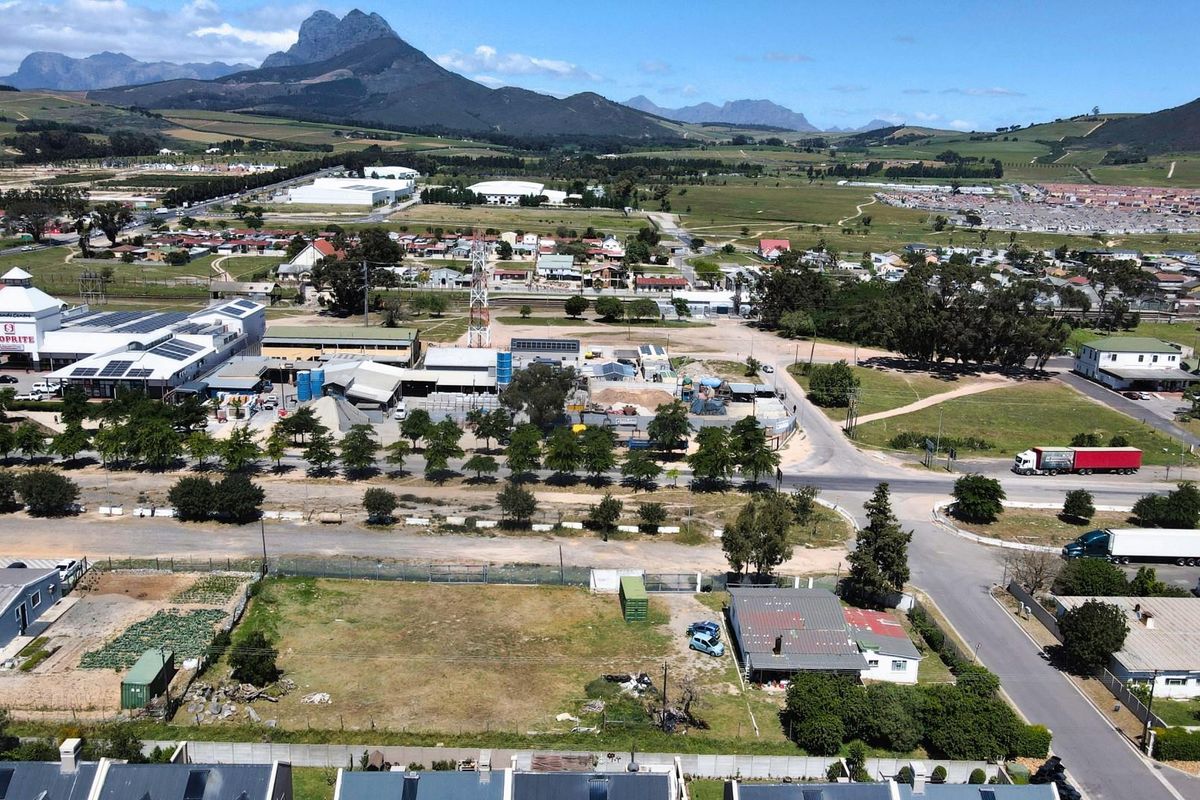 Aerial view of a vacant commercial land parcel situated in a developed area with established road access and surrounding commercial infrastructure.
