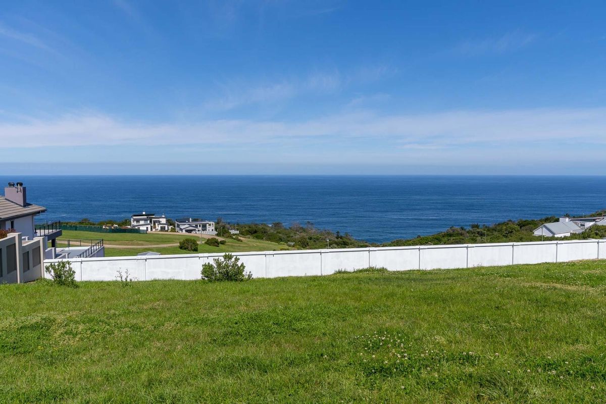 A vacant residential plot offering expansive, unobstructed ocean views and a clear coastal horizon.